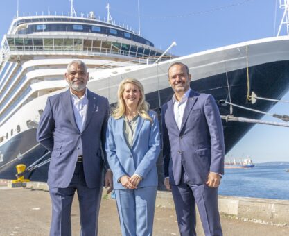 Executives from Holland America Line in front of Nieuw Amsterdam in the Port of Seattle.