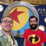 Standing in front of the Pixar Day at Sea sign on the Disney Fantasy cruise ship