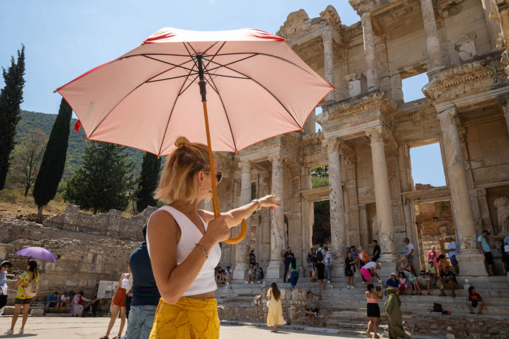 Woman with an umbrella exploring an ancient city