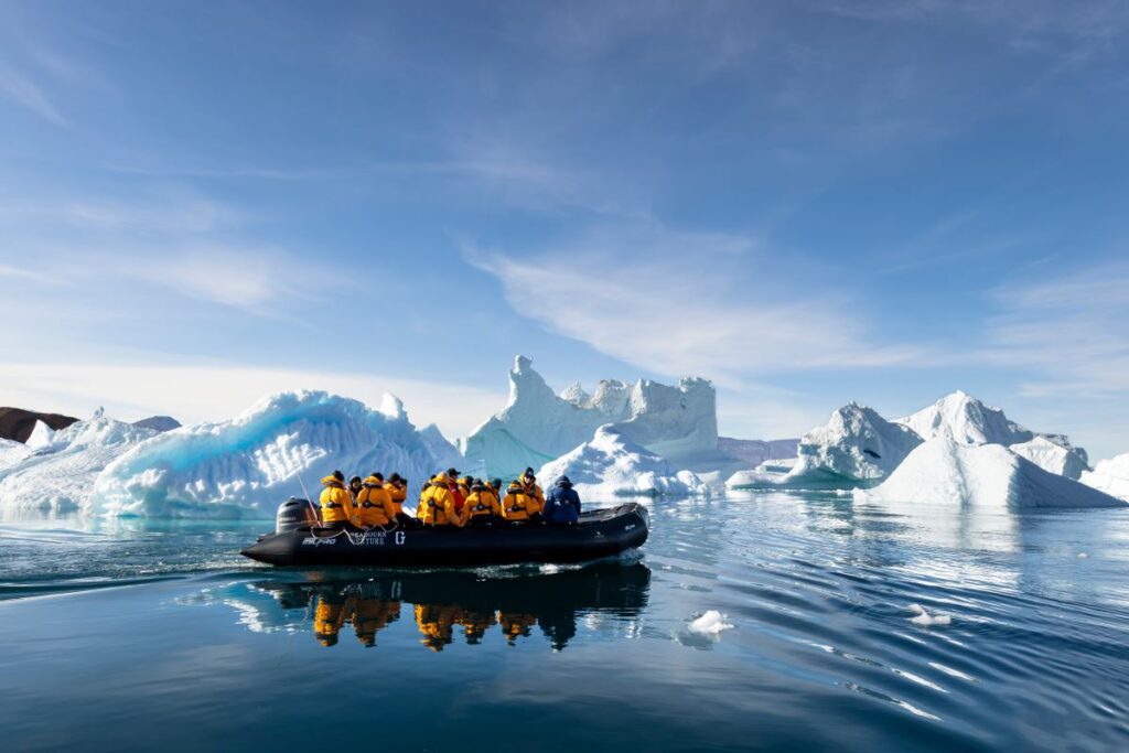 Riding on Zodiac boats among icebergs